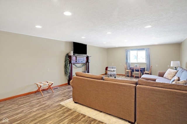 living room with hardwood / wood-style flooring and a textured ceiling