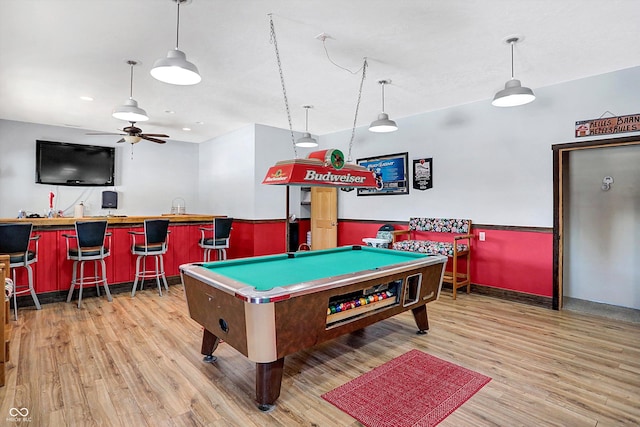 game room featuring bar, light hardwood / wood-style floors, and billiards