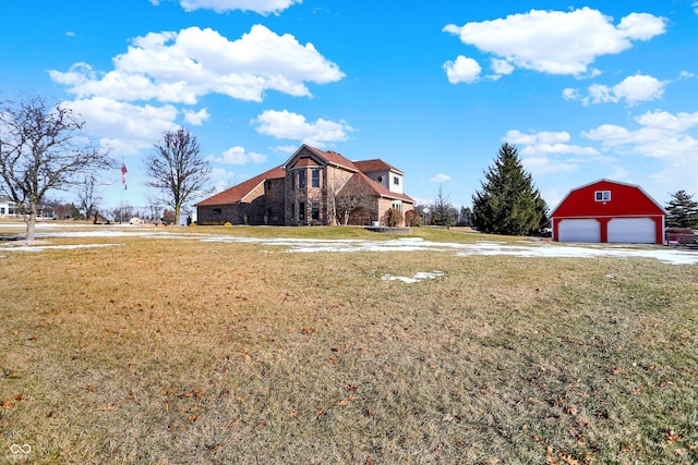 view of yard with a garage and an outdoor structure