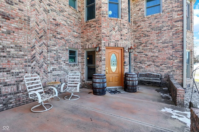 entrance to property featuring a patio area