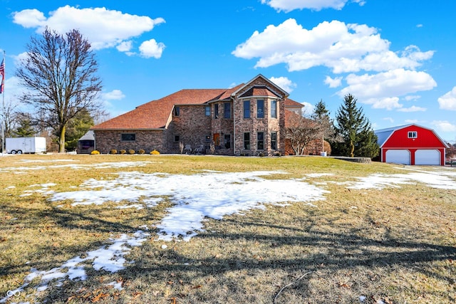 view of front of property with an outbuilding, a garage, and a lawn