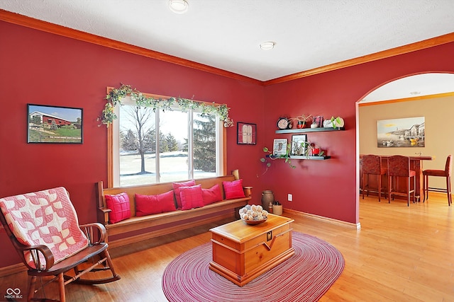 living room with hardwood / wood-style floors, crown molding, and a textured ceiling