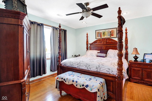 bedroom with ceiling fan, ornamental molding, and light hardwood / wood-style flooring