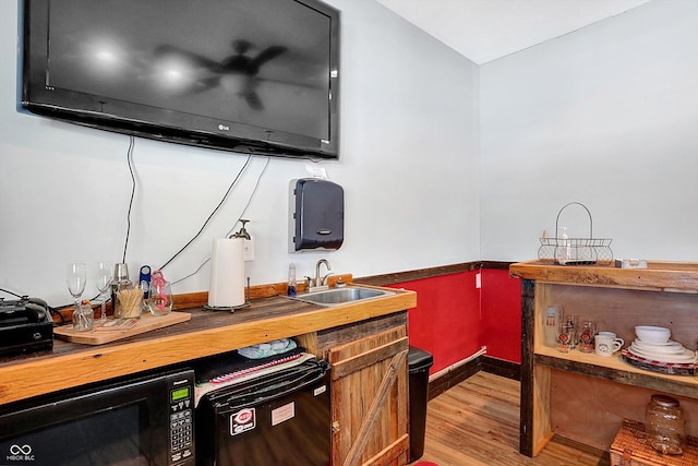 kitchen with sink and light hardwood / wood-style flooring