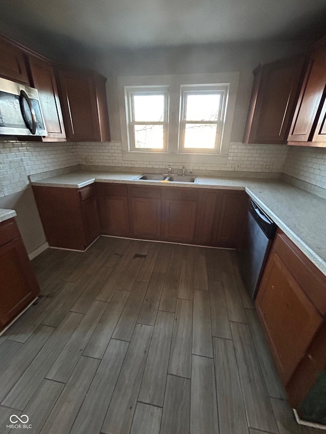 kitchen with tasteful backsplash, appliances with stainless steel finishes, and sink