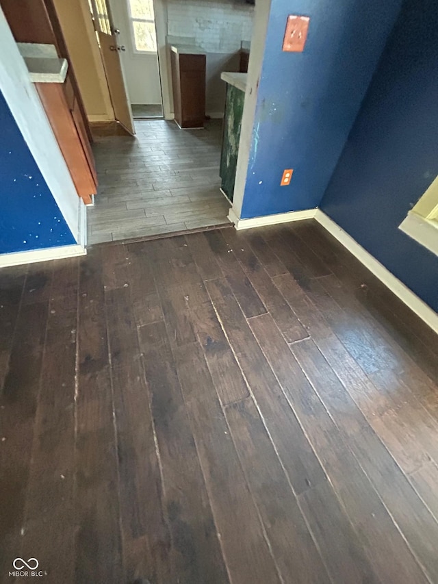 empty room with dark hardwood / wood-style flooring