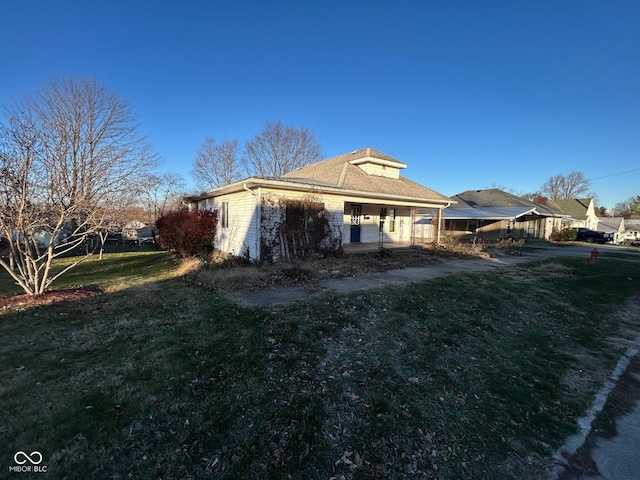 view of property exterior featuring a lawn and covered porch