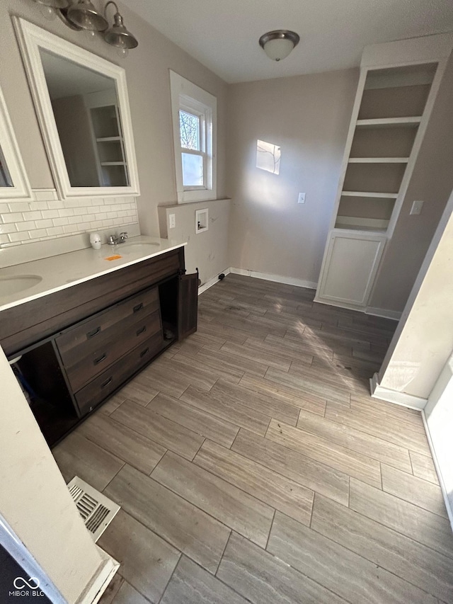 bathroom featuring backsplash and sink