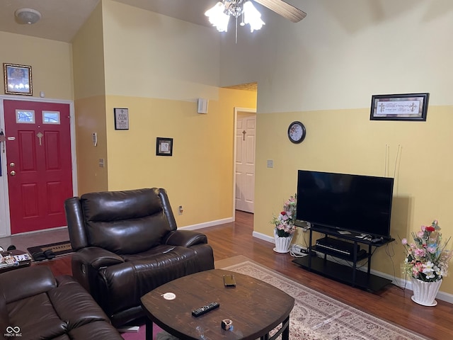 living room featuring a high ceiling, hardwood / wood-style floors, and ceiling fan