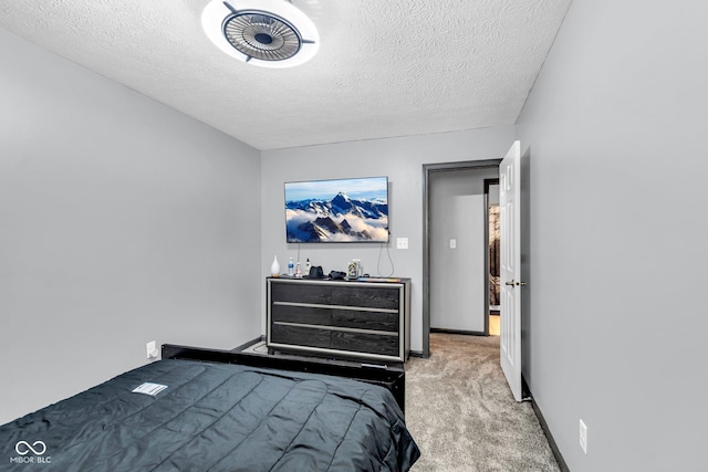 carpeted bedroom featuring a textured ceiling