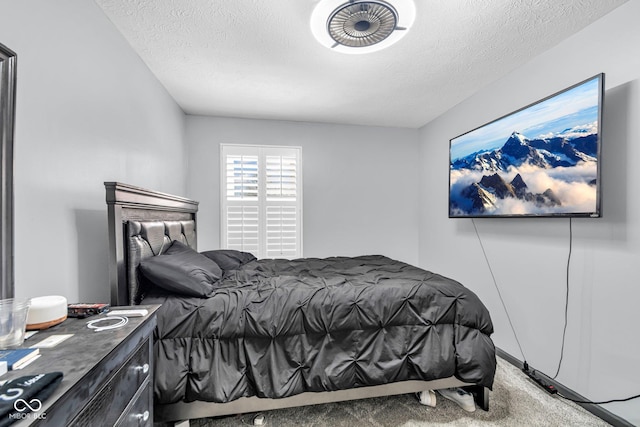 bedroom featuring a textured ceiling and carpet