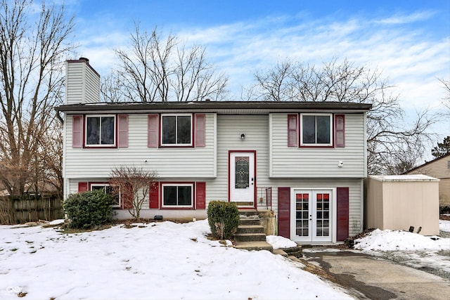 split foyer home featuring french doors