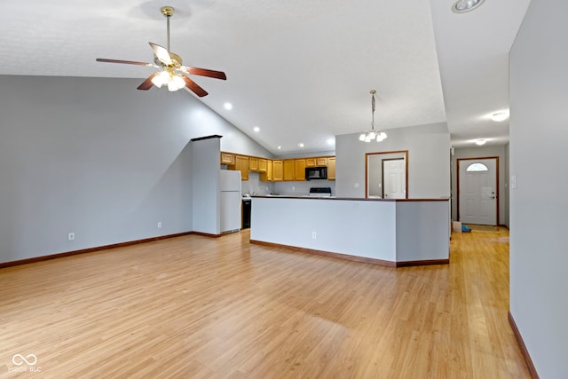 kitchen with pendant lighting, lofted ceiling, white refrigerator, ceiling fan, and light wood-type flooring