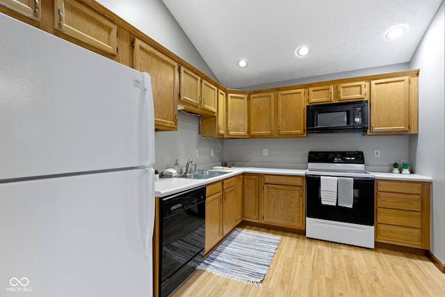 kitchen with lofted ceiling, sink, light hardwood / wood-style flooring, and black appliances