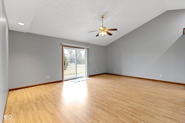 unfurnished room with vaulted ceiling, ceiling fan, and light wood-type flooring