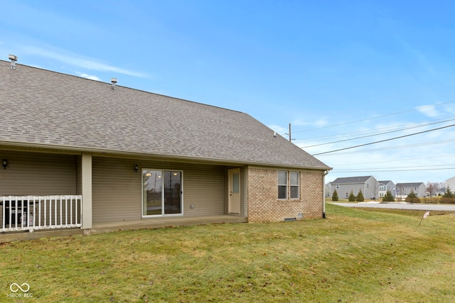 rear view of property with a yard