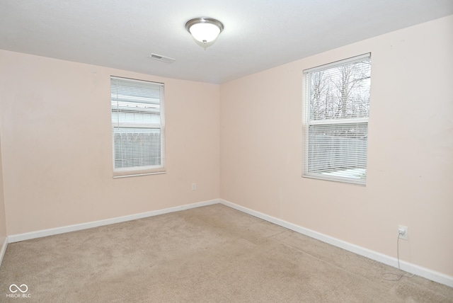 empty room with light colored carpet