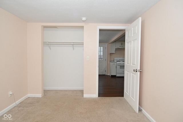 unfurnished bedroom featuring carpet and a closet