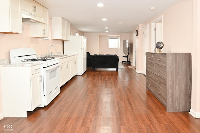 kitchen featuring dark wood-type flooring, white appliances, sink, and white cabinets