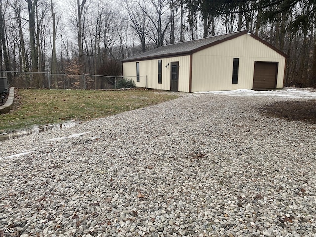 view of outbuilding with cooling unit and a garage