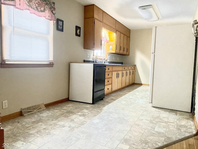 kitchen with dishwasher and white refrigerator