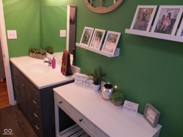 bathroom with wood finished floors and vanity