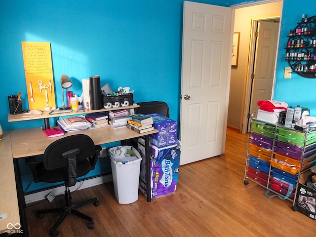 office space with wood-type flooring