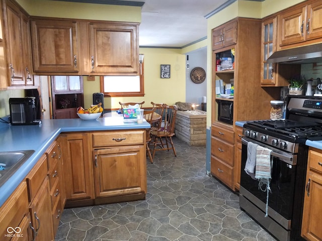 kitchen with black microwave, stainless steel gas range oven, under cabinet range hood, a peninsula, and brown cabinets