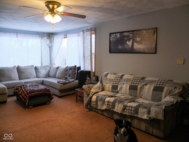 carpeted living area with ceiling fan