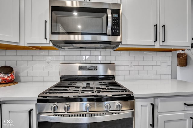 kitchen featuring appliances with stainless steel finishes, white cabinets, and backsplash