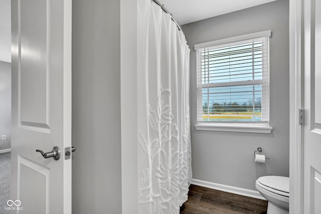 bathroom featuring hardwood / wood-style flooring and toilet