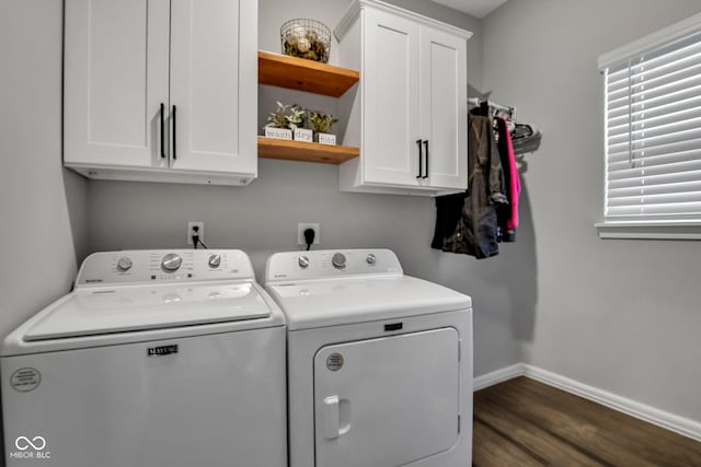 laundry room with dark hardwood / wood-style flooring, cabinets, and washer and dryer