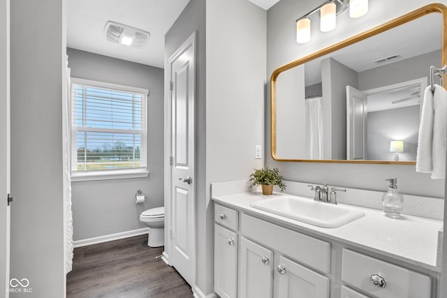 bathroom featuring hardwood / wood-style flooring, vanity, and toilet