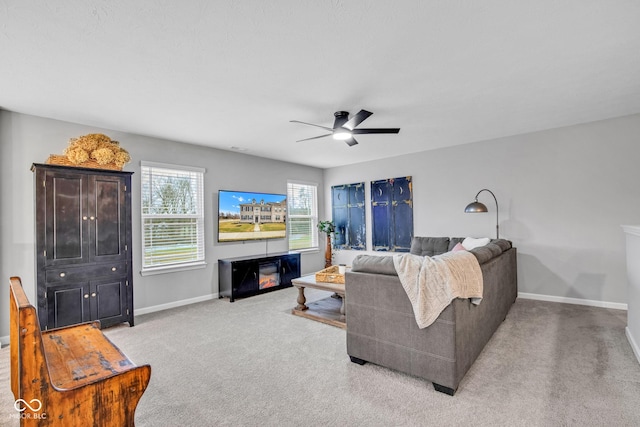 carpeted living room with ceiling fan