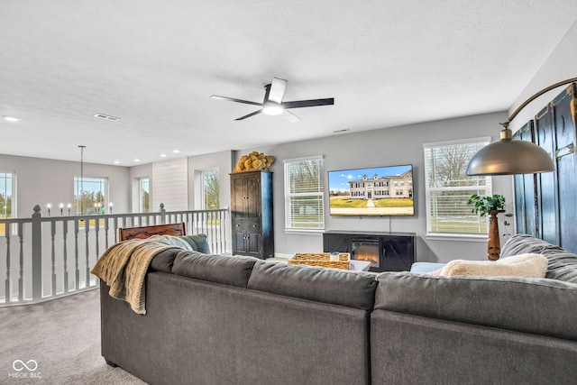 living room featuring carpet, a chandelier, and a textured ceiling