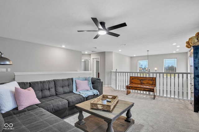 carpeted living room with a notable chandelier and a textured ceiling