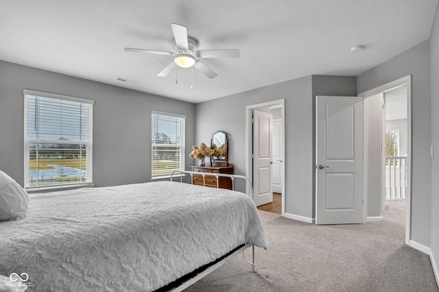 bedroom featuring light colored carpet and ceiling fan