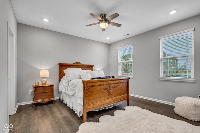 bedroom with dark hardwood / wood-style flooring and ceiling fan