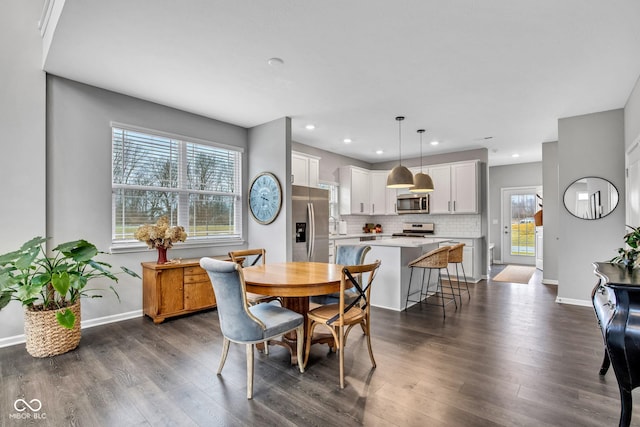 dining area with dark hardwood / wood-style flooring