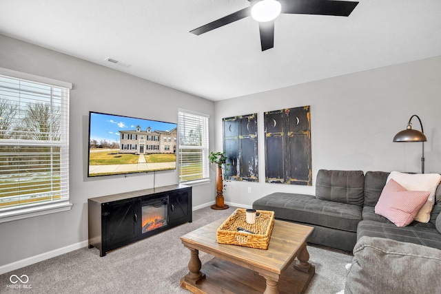 carpeted living room featuring ceiling fan