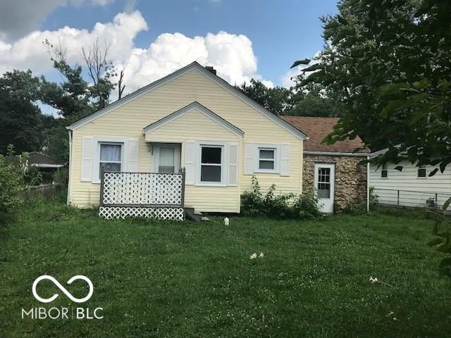 rear view of house with a yard