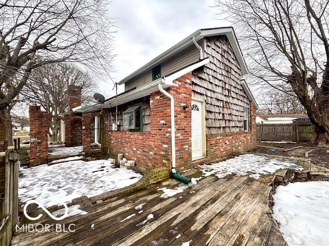 snow covered property featuring a deck