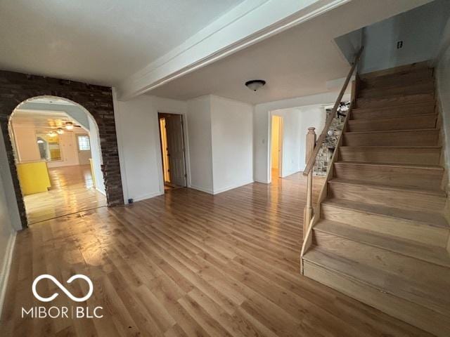 interior space featuring beam ceiling and hardwood / wood-style floors