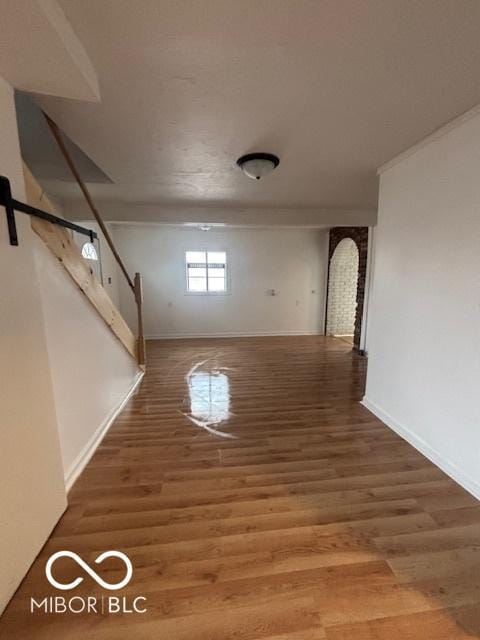 interior space with a barn door and hardwood / wood-style floors