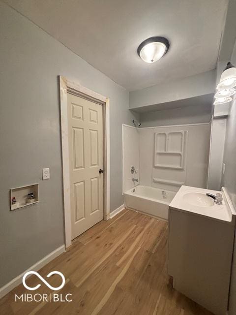 bathroom featuring hardwood / wood-style flooring, vanity, and bathtub / shower combination