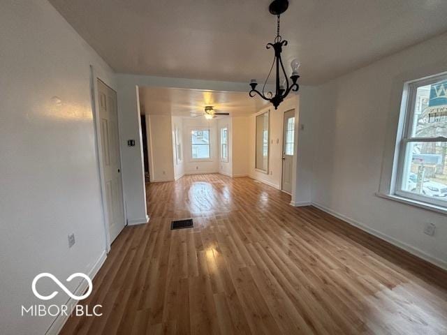 unfurnished dining area featuring hardwood / wood-style flooring and ceiling fan