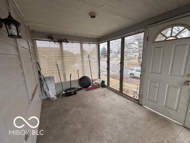 unfurnished sunroom with wood ceiling