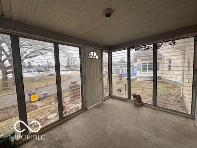 unfurnished sunroom featuring wooden ceiling