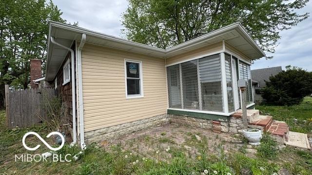 view of side of home with fence
