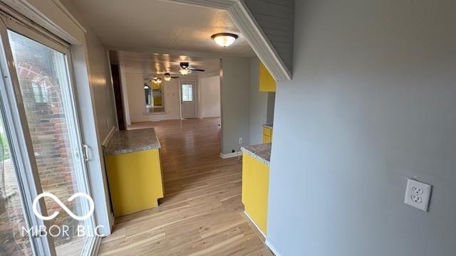 hall with baseboards and light wood finished floors